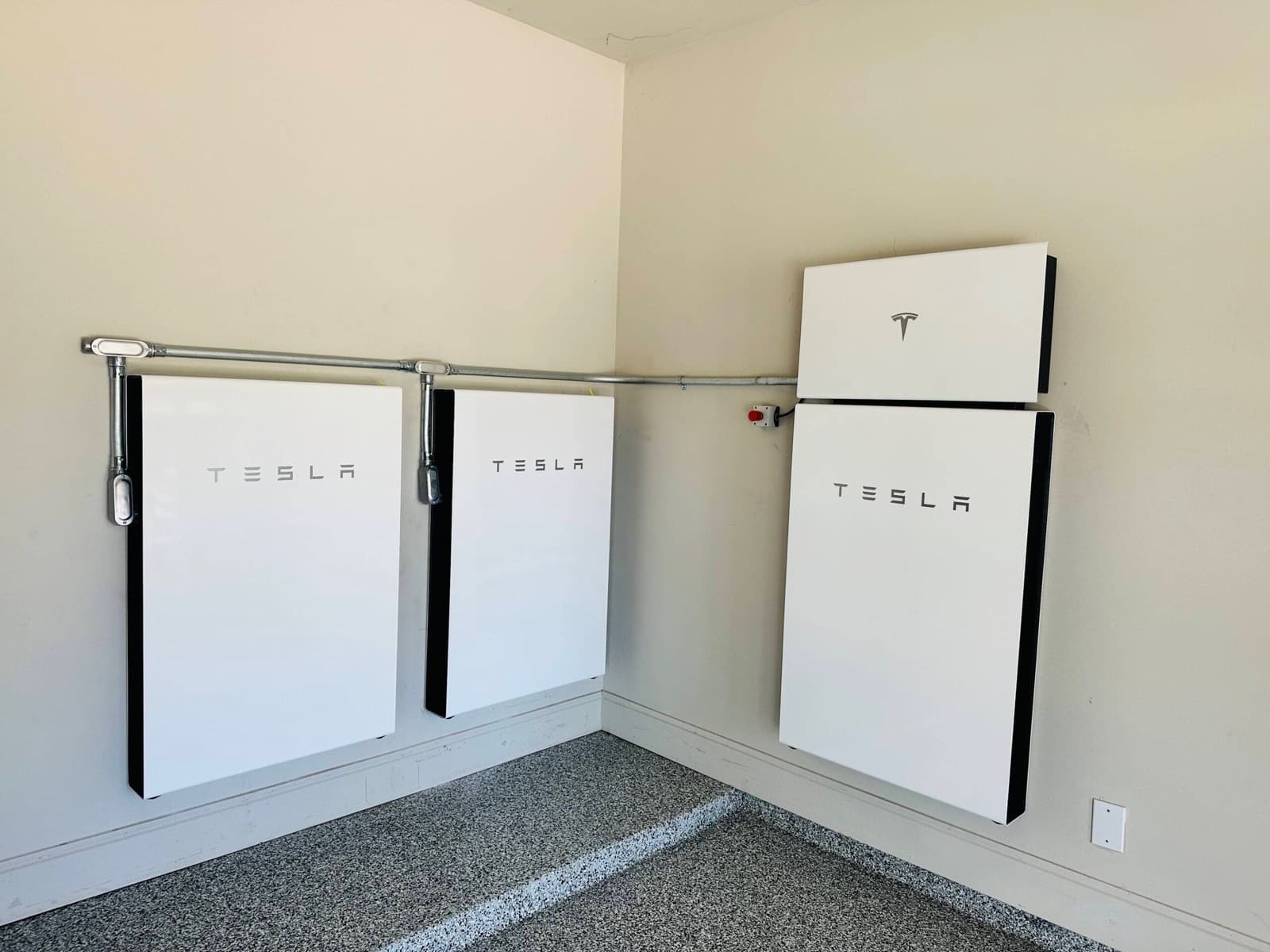 Tesla Powerwall home battery backup system installed in a garage