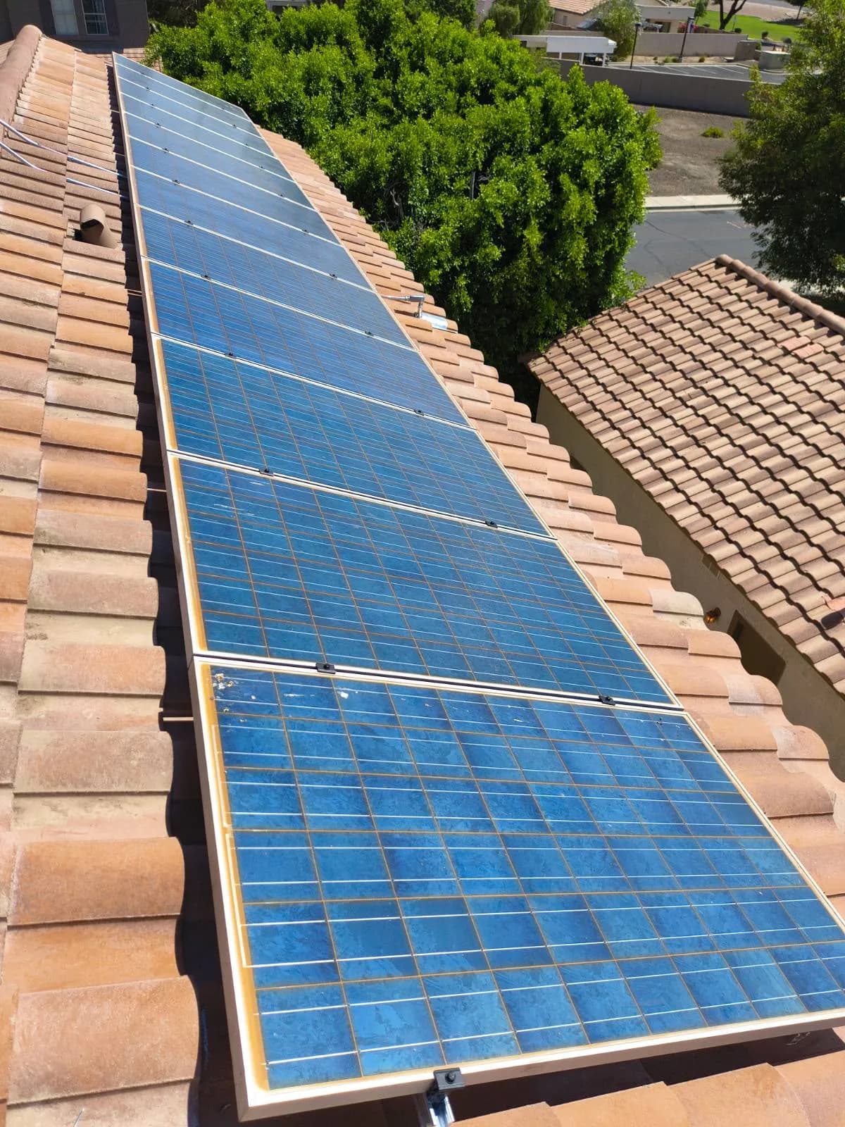 A long single row of solar panels reset on a Chandler tile roof