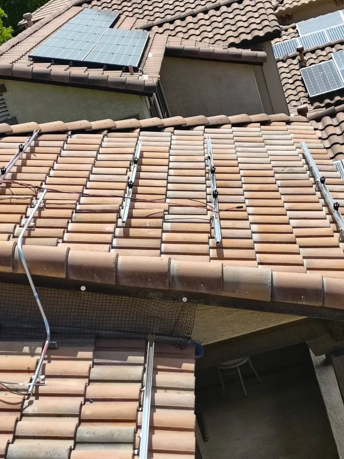 Rails and wiring left in position on a Chandler tile roof with the panels off, mid detach and reset