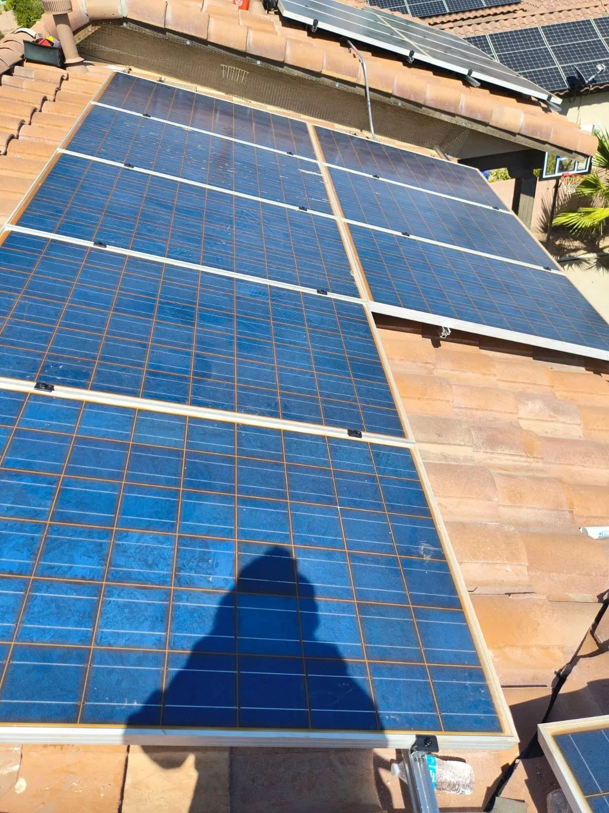 A reset solar array on a Chandler tile roof, panels back on their rails