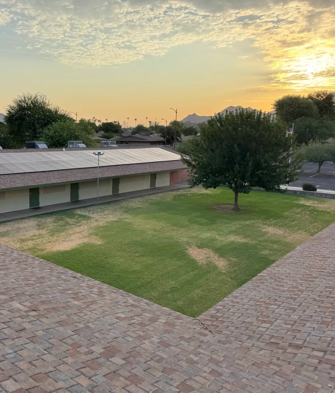 Solar array reset on the roof of a long single storey building in Phoenix, shot at sunset