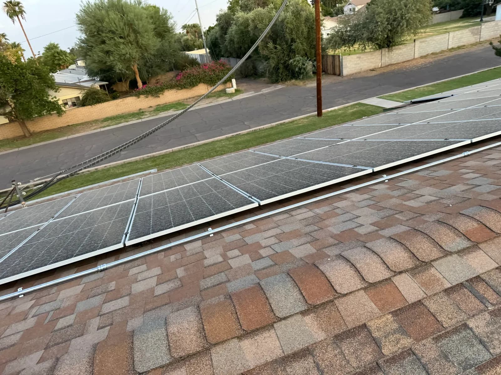 Solar panels reset on a Phoenix shingle roof with the conduit and rails back in place