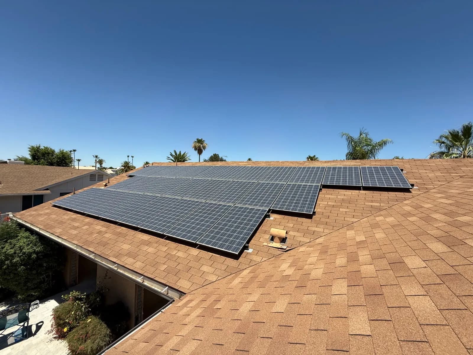 A completed solar panel reset on a Scottsdale shingle roof, the array back down in one clean block
