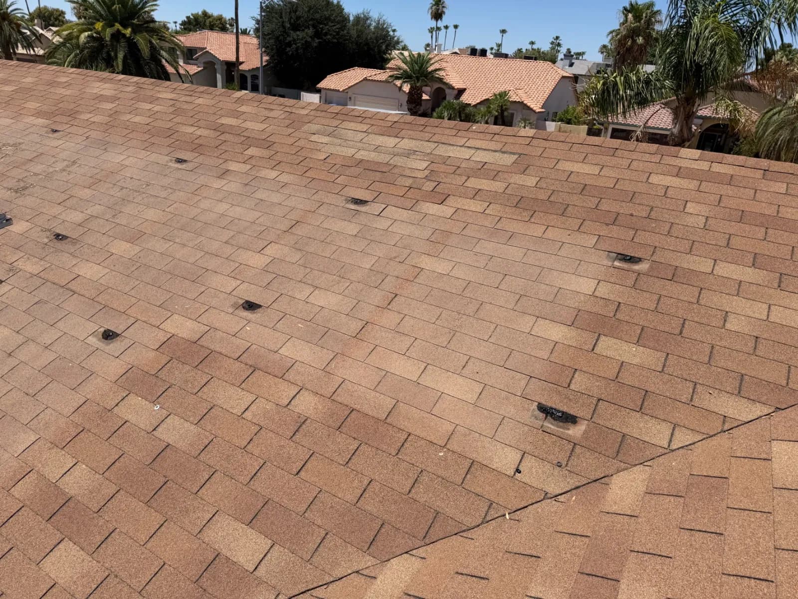 A Scottsdale shingle roof cleared of solar panels, mounting points left in position for the reset