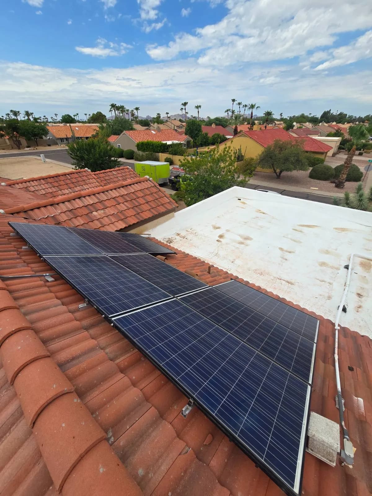 Solar panels reset on the sloped section of a Scottsdale roof, with the flat roof section alongside