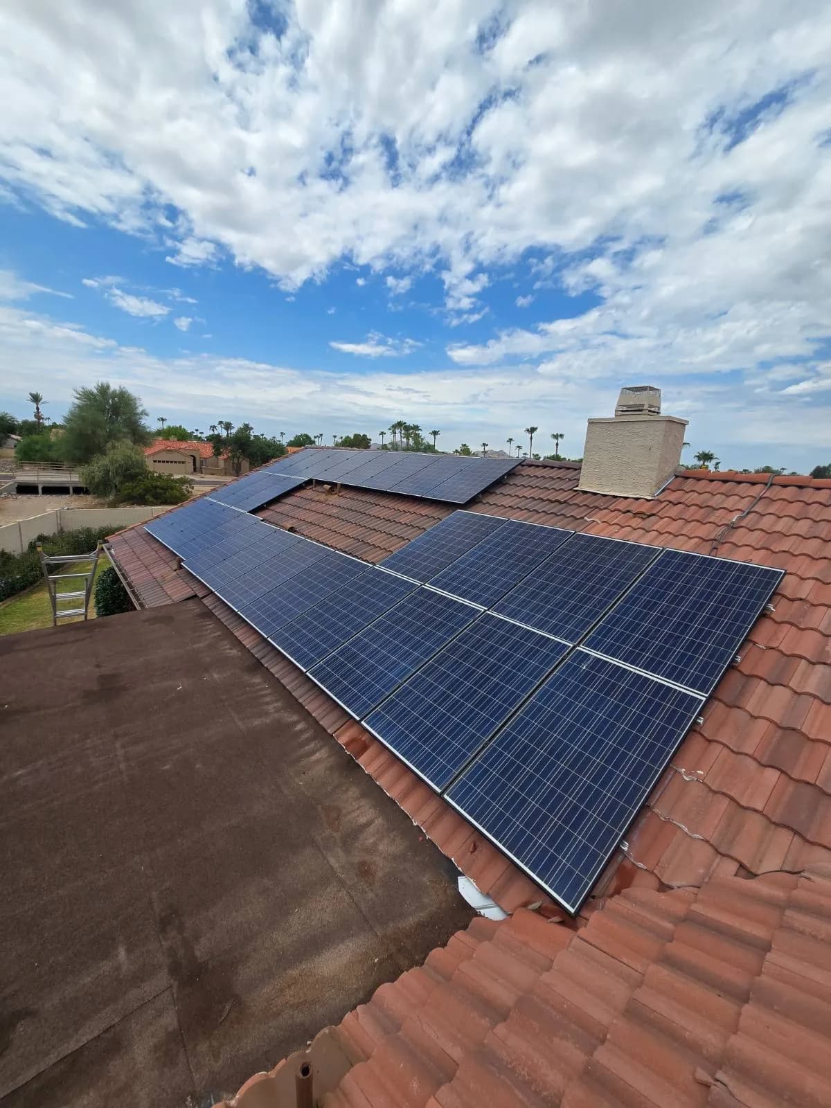 A reset solar array on a Scottsdale tile roof beside the chimney